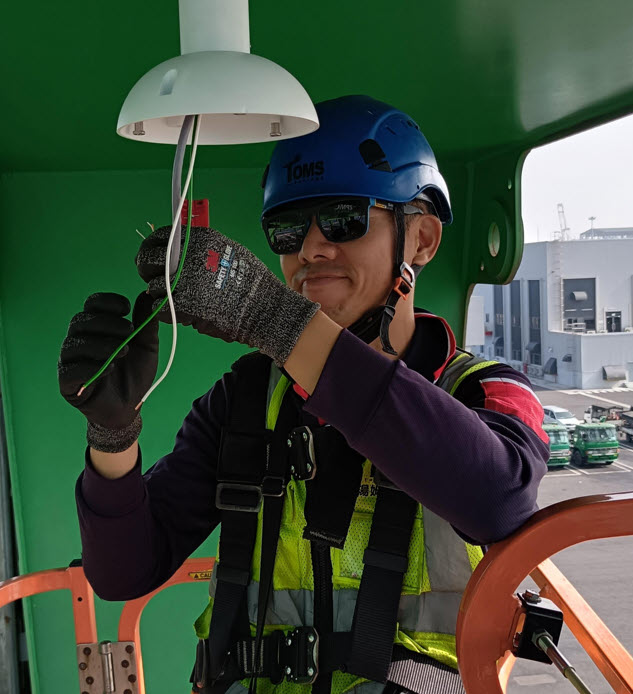 Portrait of Thomas Chen, CEO, wearing a suit in a modern office